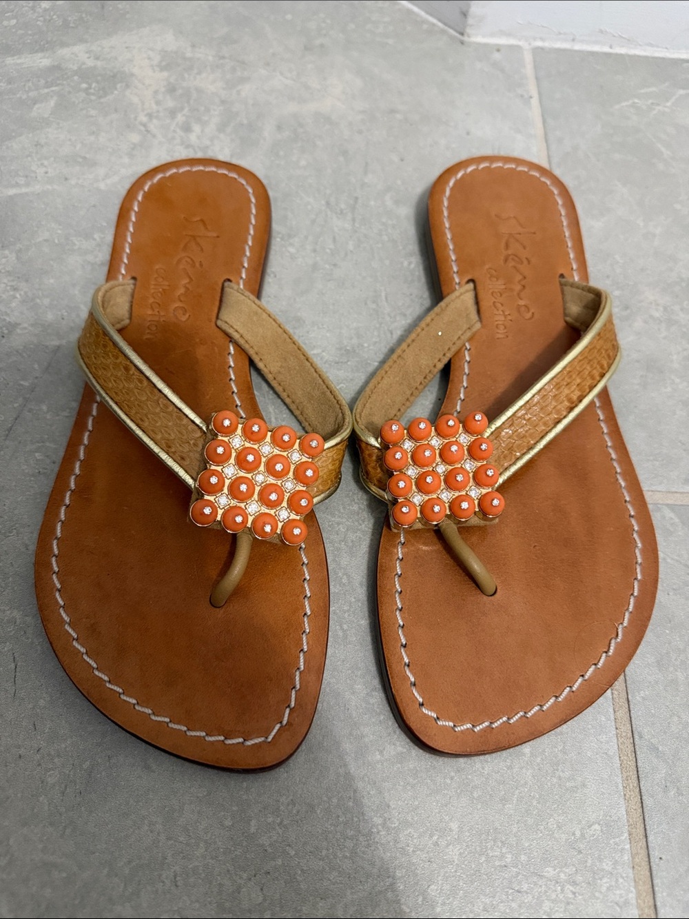 Skemo Collection tan sandals with orange and crystal center decoration. Sz 7.